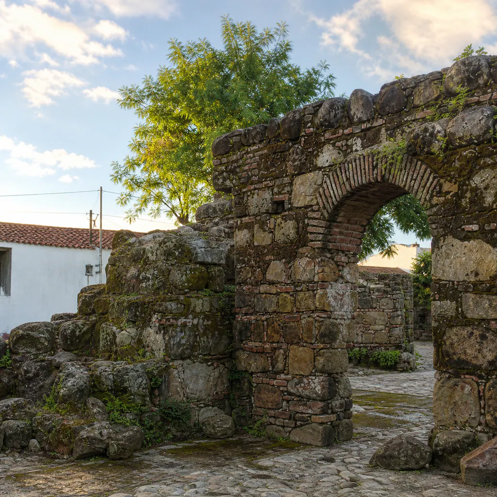 Early morning light crossing the weathered stone-and-brick arches of the colonial Ruinas de Pore in Pore, Casanare.